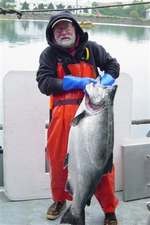 Seafood Producers Cooperative member with a troll-caught wild king salmon from Southeast Alaska